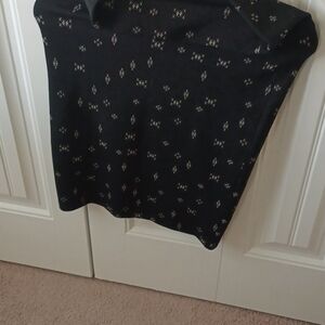 A lularoe black skirt. It has cream colored x on it. It is an XS